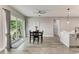 Bright dining area with modern table set, sliding glass door leading to outdoor patio, and open access to kitchen at 4314 Des Plaines Dr, Sarasota, FL 34233