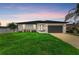 Charming one-story home featuring a manicured lawn and lush landscaping at dusk at 4314 Des Plaines Dr, Sarasota, FL 34233