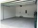 Clean and bright garage featuring a sealed concrete floor, door to the house, and ample space at 4314 Des Plaines Dr, Sarasota, FL 34233