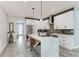 Stylish kitchen featuring white cabinets, a gray backsplash, stainless appliances, and a large island with seating at 4314 Des Plaines Dr, Sarasota, FL 34233