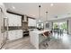 Open-concept kitchen with quartz countertops, stainless steel appliances, and a breakfast bar at 4314 Des Plaines Dr, Sarasota, FL 34233