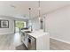 Bright kitchen featuring a large island with a marble countertop, pendant lights, and stainless steel appliances at 4314 Des Plaines Dr, Sarasota, FL 34233