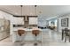 Modern kitchen with stainless steel appliances, a center island with a bar, and sleek white cabinets at 4314 Des Plaines Dr, Sarasota, FL 34233