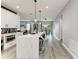 Open-concept kitchen with quartz countertops, stainless steel appliances, and modern pendant lighting at 4314 Des Plaines Dr, Sarasota, FL 34233