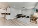Open-concept living room showcasing hardwood floors and seamless transition from kitchen to living space at 4314 Des Plaines Dr, Sarasota, FL 34233