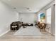 Comfortable living room featuring hardwood floors, a ceiling fan, modern furniture, and natural lighting at 4314 Des Plaines Dr, Sarasota, FL 34233