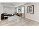 Inviting living room with neutral walls, modern furniture, a ceiling fan, and gray wood-look floors at 4314 Des Plaines Dr, Sarasota, FL 34233