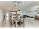 Open living space with modern gray floors, connecting the kitchen, dining area, and living room at 4314 Des Plaines Dr, Sarasota, FL 34233