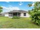 Large, green backyard with a screened patio and mature trees, providing privacy at 4649 72Nd E Ct, Bradenton, FL 34203