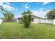 Expansive backyard showcases a pristine lawn, mature trees and a fence, offering privacy at 4649 72Nd E Ct, Bradenton, FL 34203