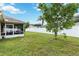 Expansive backyard featuring lush grass, mature trees, and a screened patio at 4649 72Nd E Ct, Bradenton, FL 34203