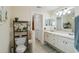 Well-lit bathroom featuring white cabinets and a neutral color scheme for a clean and modern look at 4649 72Nd E Ct, Bradenton, FL 34203