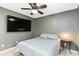 Relaxing bedroom featuring a ceiling fan, neutral paint color, and mounted TV for entertainment at 4649 72Nd E Ct, Bradenton, FL 34203