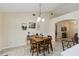 Cozy dining area featuring a wooden table with seating for four, adjacent to a spacious living room at 4649 72Nd E Ct, Bradenton, FL 34203