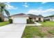 Inviting single-story home featuring a well-maintained lawn, a two-car garage, and a sidewalk leading to the front door at 4649 72Nd E Ct, Bradenton, FL 34203