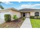 Close-up of a home's entrance showcasing a well-kept lawn, a sidewalk, and a neatly landscaped garden at 4649 72Nd E Ct, Bradenton, FL 34203