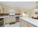 Bright kitchen with light wood cabinets, white countertops, stainless steel appliances, and a breakfast bar at 4649 72Nd E Ct, Bradenton, FL 34203