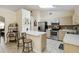 Modern kitchen featuring stainless steel appliances and bar seating adjacent to dining area at 4649 72Nd E Ct, Bradenton, FL 34203