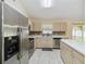 Well-lit kitchen featuring stainless steel appliances, tile backsplash, and a functional center island at 4649 72Nd E Ct, Bradenton, FL 34203