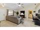 Bright living room featuring vaulted ceilings, tile floors, a comfortable sofa, and a stylish workstation at 4649 72Nd E Ct, Bradenton, FL 34203