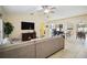 Spacious living room with tile floors, a large sectional, an entertainment center, and an adjacent dining area at 4649 72Nd E Ct, Bradenton, FL 34203