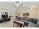 Spacious living room featuring tile floors, a comfortable sectional, and modern decor at 4649 72Nd E Ct, Bradenton, FL 34203