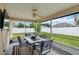 Screened patio that has an outdoor dining area with seating and fan at 4649 72Nd E Ct, Bradenton, FL 34203