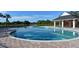 Community swimming pool with a brick surround and a nearby covered pavilion for shade on a sunny day with blue skies at 4649 72Nd E Ct, Bradenton, FL 34203