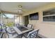 Relaxing screened-in patio with an outdoor television and backyard views at 4649 72Nd E Ct, Bradenton, FL 34203