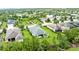 An aerial view shows the house, manicured lawn, landscaping, and community water feature at 4654 Claremont Park Dr, Bradenton, FL 34211