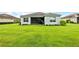 Expansive backyard with lush green grass and screened in porch - perfect for outdoor relaxation and activities at 4654 Claremont Park Dr, Bradenton, FL 34211