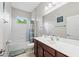 Bright bathroom features a shower-tub combo and vanity with storage at 4654 Claremont Park Dr, Bradenton, FL 34211