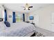 Bright bedroom with ceiling fan, tv, and natural light filtering through the window at 4654 Claremont Park Dr, Bradenton, FL 34211