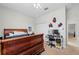 Comfortable bedroom features carpeted floors, a closet, and an organized desk at 4654 Claremont Park Dr, Bradenton, FL 34211