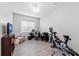 Bonus room features desk and chair with a variety of exercise equipment at 4654 Claremont Park Dr, Bradenton, FL 34211