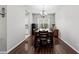 Formal dining room with dark wood floors, a chandelier, and natural light from the window at 4654 Claremont Park Dr, Bradenton, FL 34211