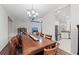 Open concept dining area featuring a large table, hardwood floors, and access to the kitchen at 4654 Claremont Park Dr, Bradenton, FL 34211