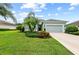 View of a well-kept home with a lush front yard, manicured landscaping, and inviting curb appeal at 4654 Claremont Park Dr, Bradenton, FL 34211
