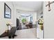 Open-concept foyer with hardwood floors, a view of the living area, and neutral decor at 4654 Claremont Park Dr, Bradenton, FL 34211