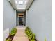 Inviting front entrance featuring a black door, elegant transom window, and landscaped walkway at 4654 Claremont Park Dr, Bradenton, FL 34211