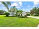 View of a well-kept home with a lush front yard, manicured landscaping, and inviting curb appeal at 4654 Claremont Park Dr, Bradenton, FL 34211