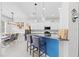 Modern kitchen with a breakfast bar, pendant lighting, and stainless steel appliances at 4654 Claremont Park Dr, Bradenton, FL 34211