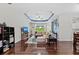 Spacious living room featuring hardwood floors, a coffered ceiling, and comfortable seating at 4654 Claremont Park Dr, Bradenton, FL 34211