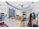 Bright living room with a coffered ceiling, hardwood floors, and neutral-toned furnishings at 4654 Claremont Park Dr, Bradenton, FL 34211