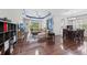Spacious living room featuring hardwood floors, a coffered ceiling, and comfortable seating at 4654 Claremont Park Dr, Bradenton, FL 34211