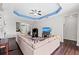 Open living area with a tray ceiling, hardwood flooring, and an entertainment center at 4654 Claremont Park Dr, Bradenton, FL 34211