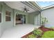 Covered patio with ceiling fan, sliding doors, and well-kept landscaping at 4654 Claremont Park Dr, Bradenton, FL 34211