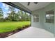 Covered patio featuring a ceiling fan and views of the manicured lawn and mature trees at 4654 Claremont Park Dr, Bradenton, FL 34211