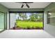 Enclosed patio shows backyard lawn and green landscaping through screen at 4654 Claremont Park Dr, Bradenton, FL 34211