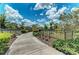 Scenic walking path with lush greenery, flowering trees, and park benches for a relaxing outdoor experience at 4654 Claremont Park Dr, Bradenton, FL 34211